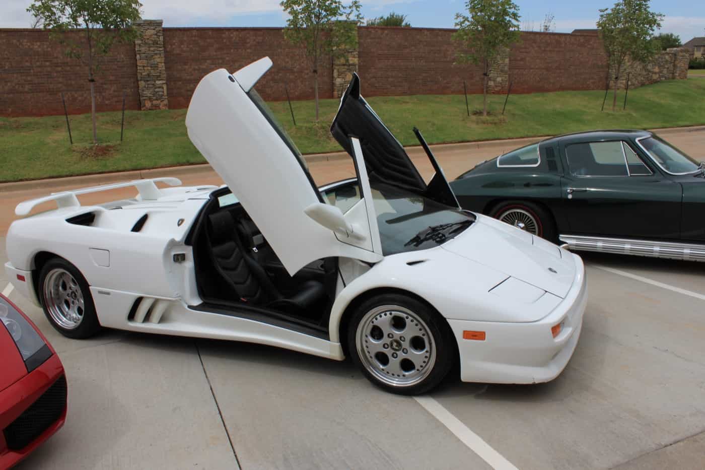 White Lamborghini Diablo VT Roadster with scissor doors up after a detail